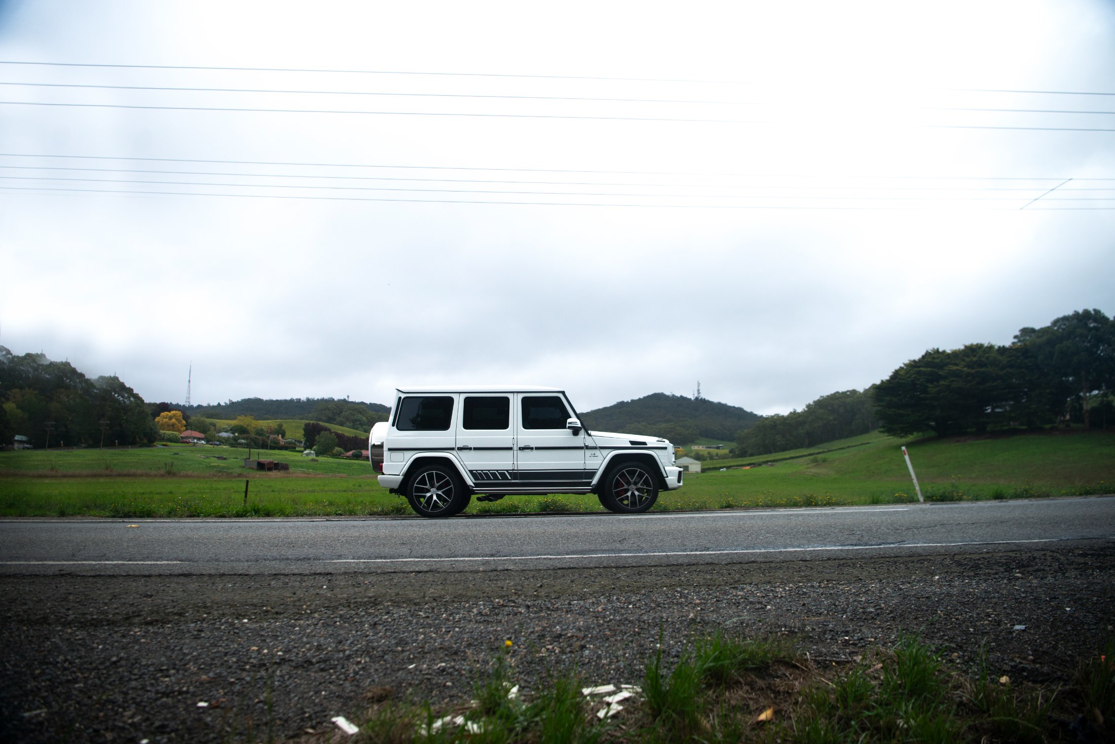 Pearl-white Mercedes-AMG G 63 on a country road near Adelaide